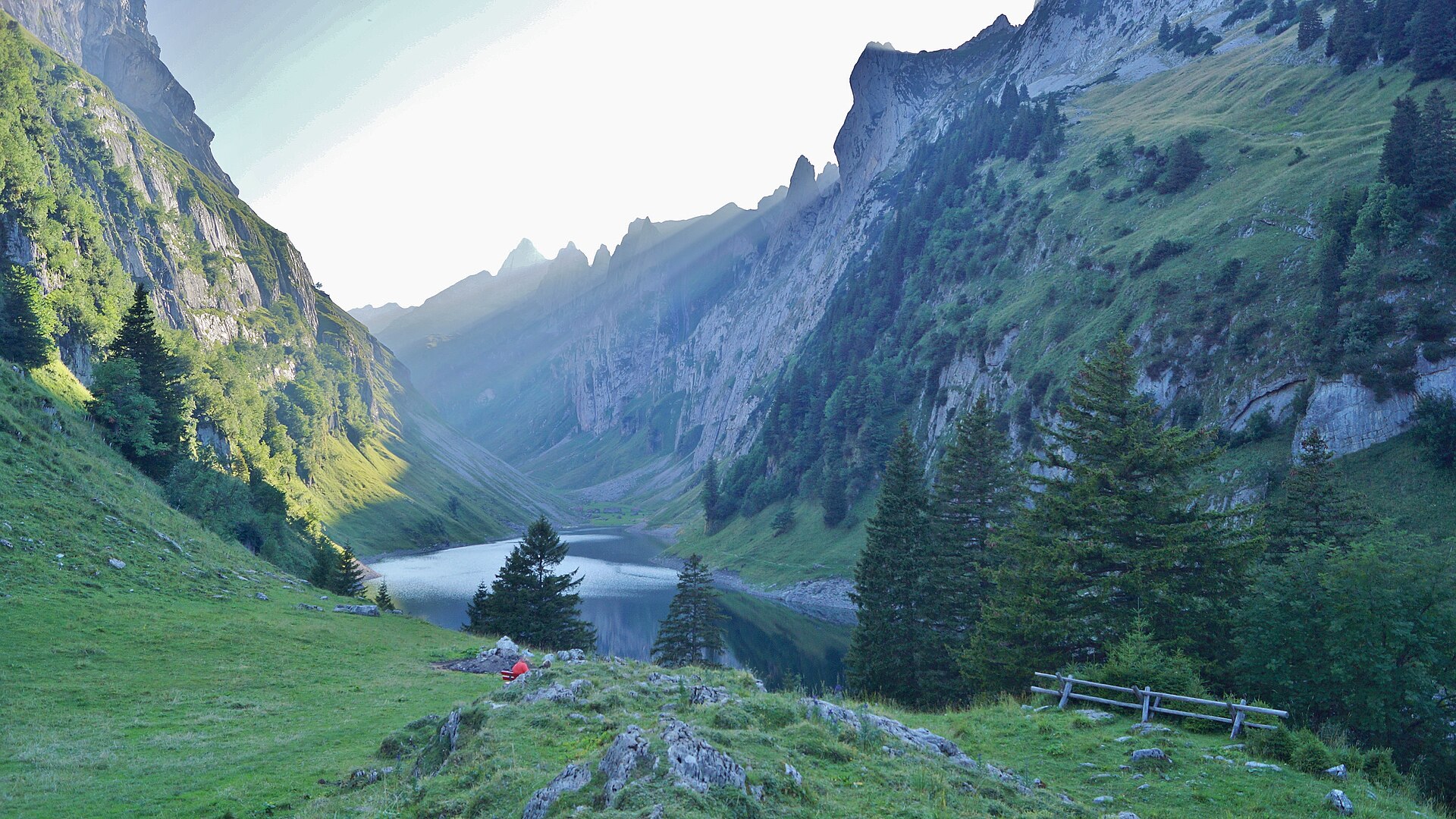 Fählensee held between steep green Alpstein ridges near Berggasthaus Bollenwees.
