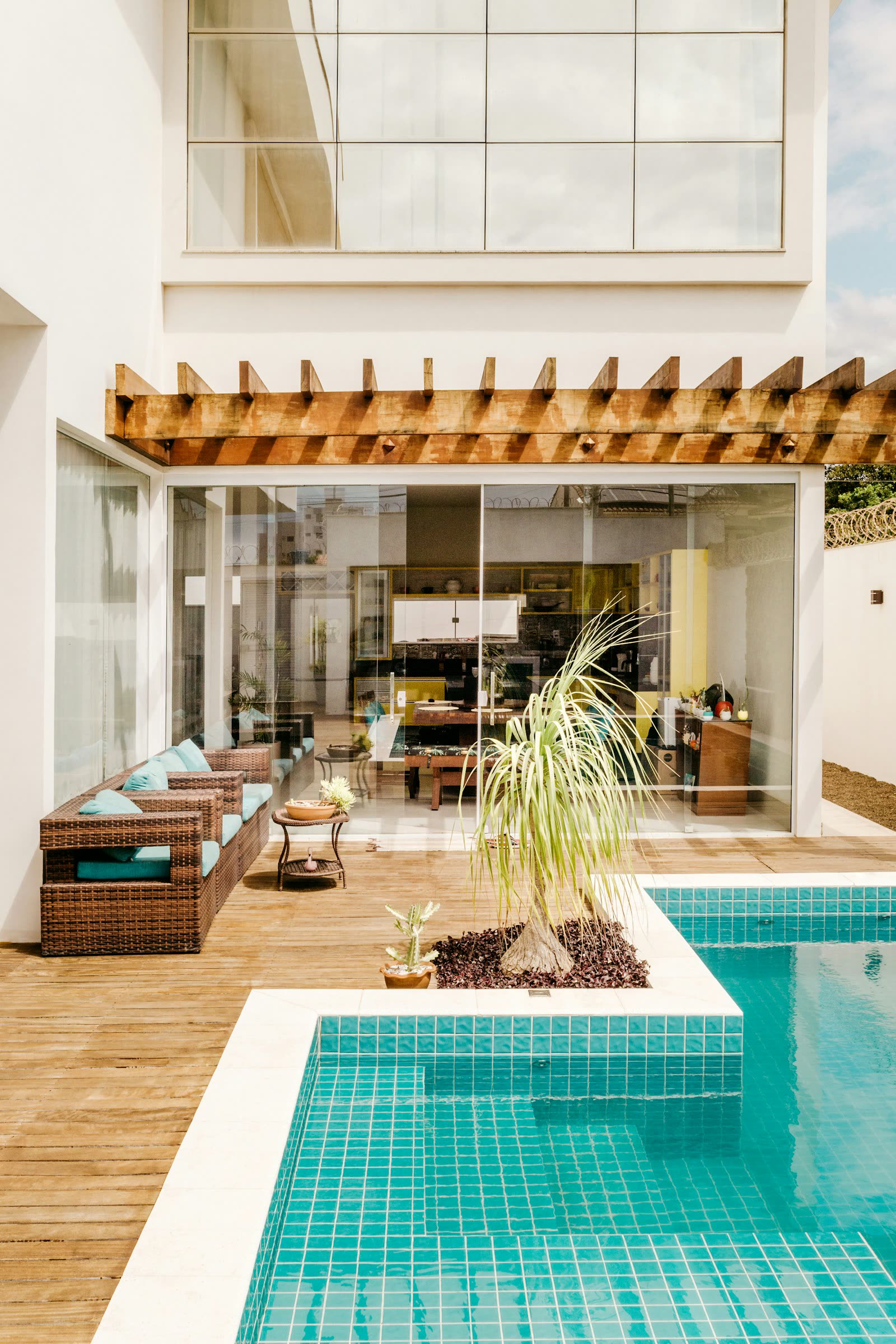 Warm tiled pool, timber deck and palm beside a bright modern retreat; a licensed spa mood image, not Therme Euskirchen.