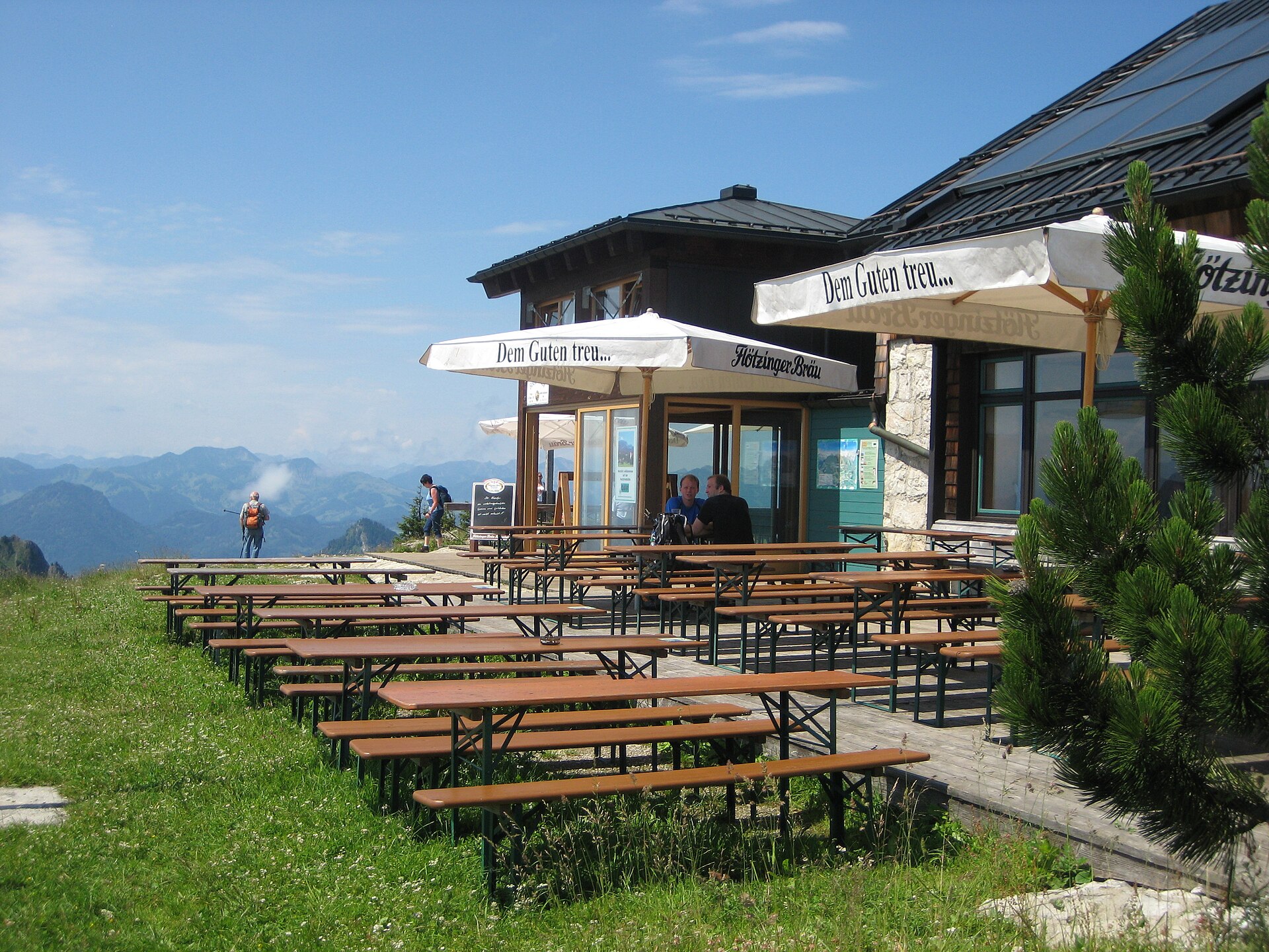 Hochries summit hut on a broad green Bavarian summit under a clear sky.